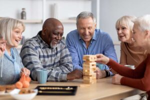 Older adult and family member reviewing a care assessment checklist at a kitchen table.